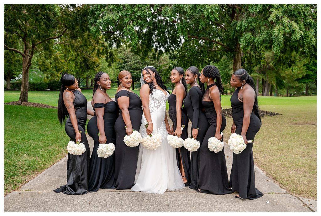 Bridesmaids dressed in black gowns with bride at The Dominion Club 