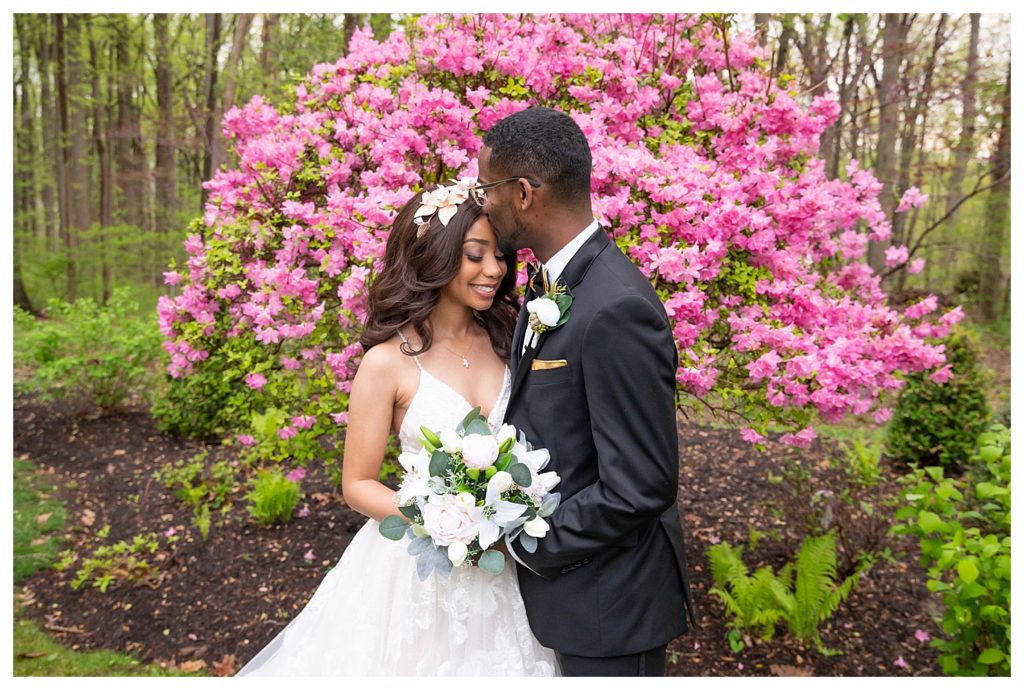 African American wedding couple posed hugging in formal attire at Liriodendron Mansion