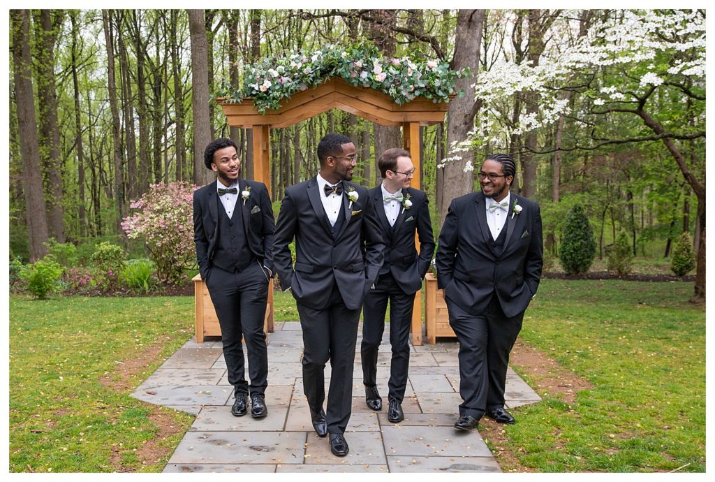 Groomsmen bridal party portrait of them walking and engaging with each other in laughter taken by LaTonya Smothers of LaTonya Photography