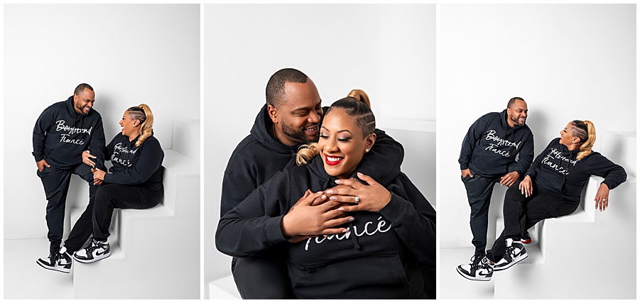 Candid studio engagement session in casual black sweatsuits.